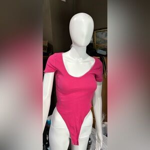 Pink short sleeve shirt with attached buttons for underneath